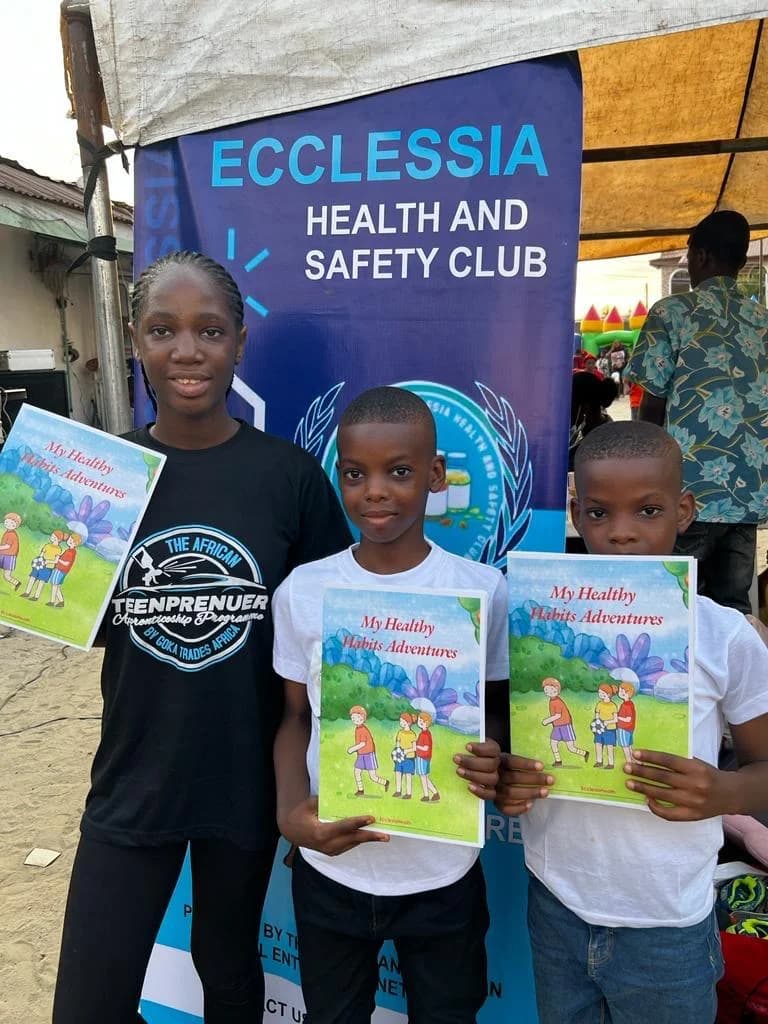 Children holding My Healthy Habits Adventures booklets at an Ecclesia outreach